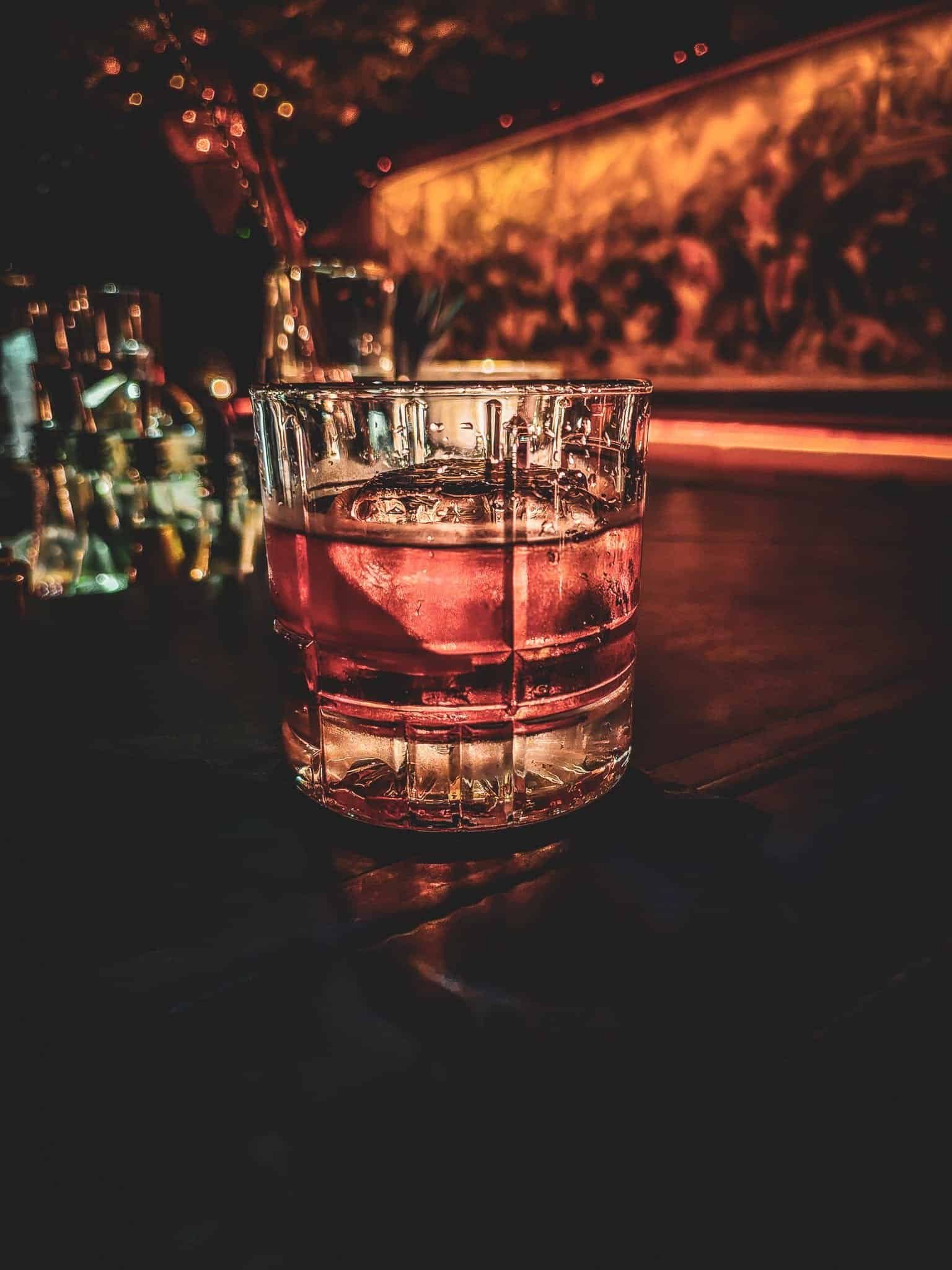 The bottle-covered ceiling and bar at Iron Balls gin bar in Bangkok