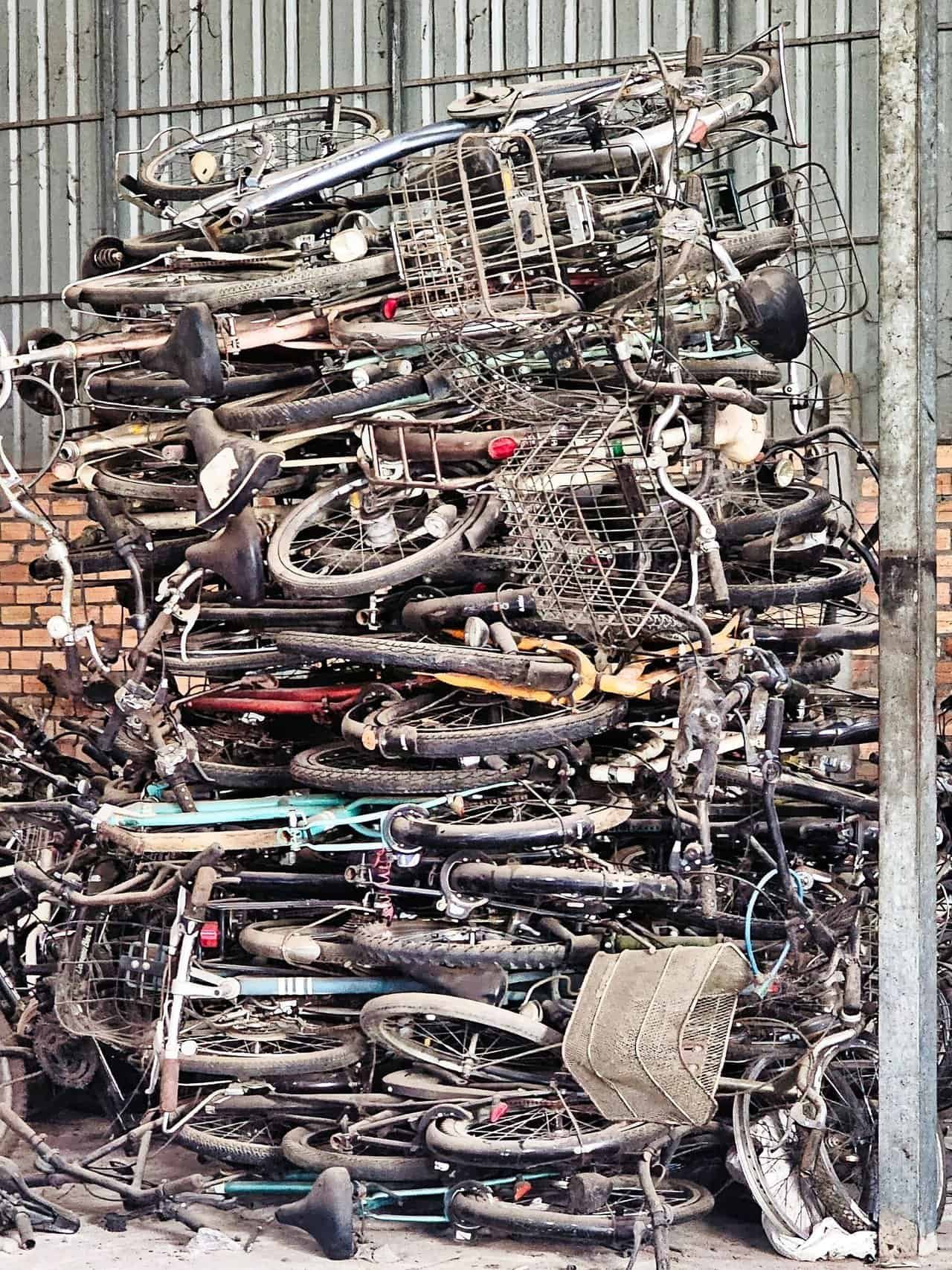 Bikes for cambodian kids: 26 bikes built on pure grit 8 » 2026 » roaming sparrow Mountian of used bikes at the bike shop in the back room.