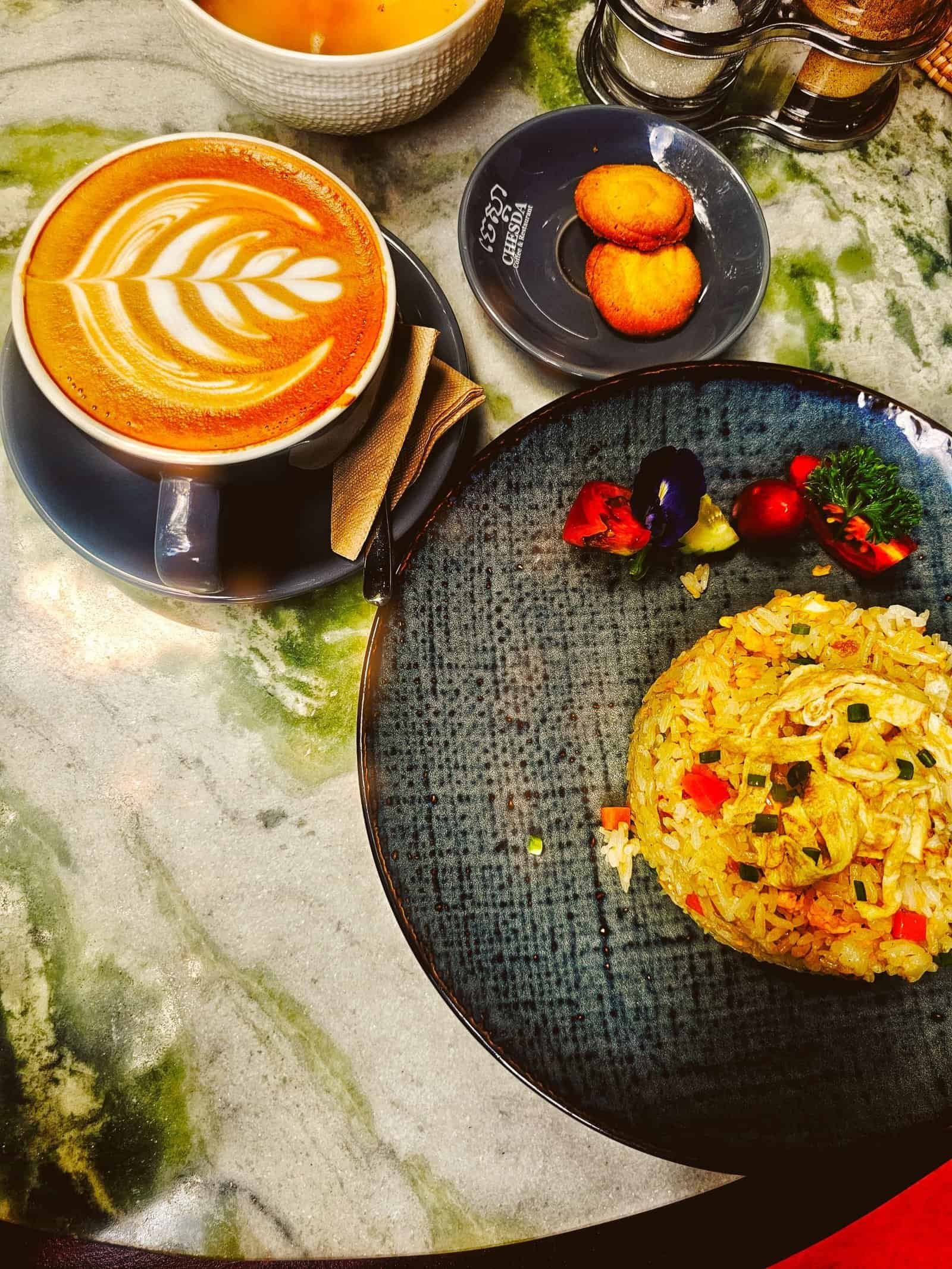 Coffee with latte art and food at Chesda garden cafe, Siem Reap