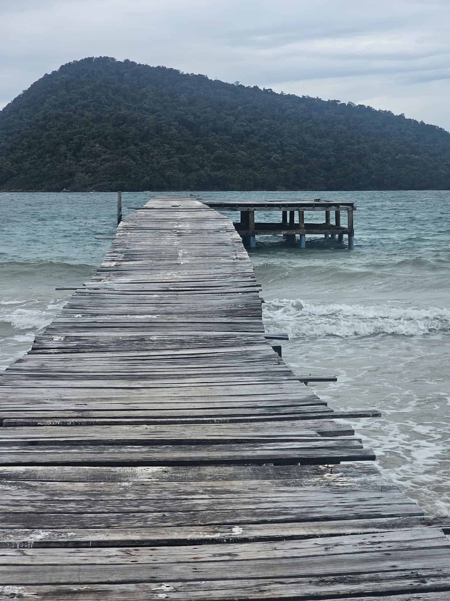 The weathered old pier at the far end of the beach on Koh Rong Sanloem