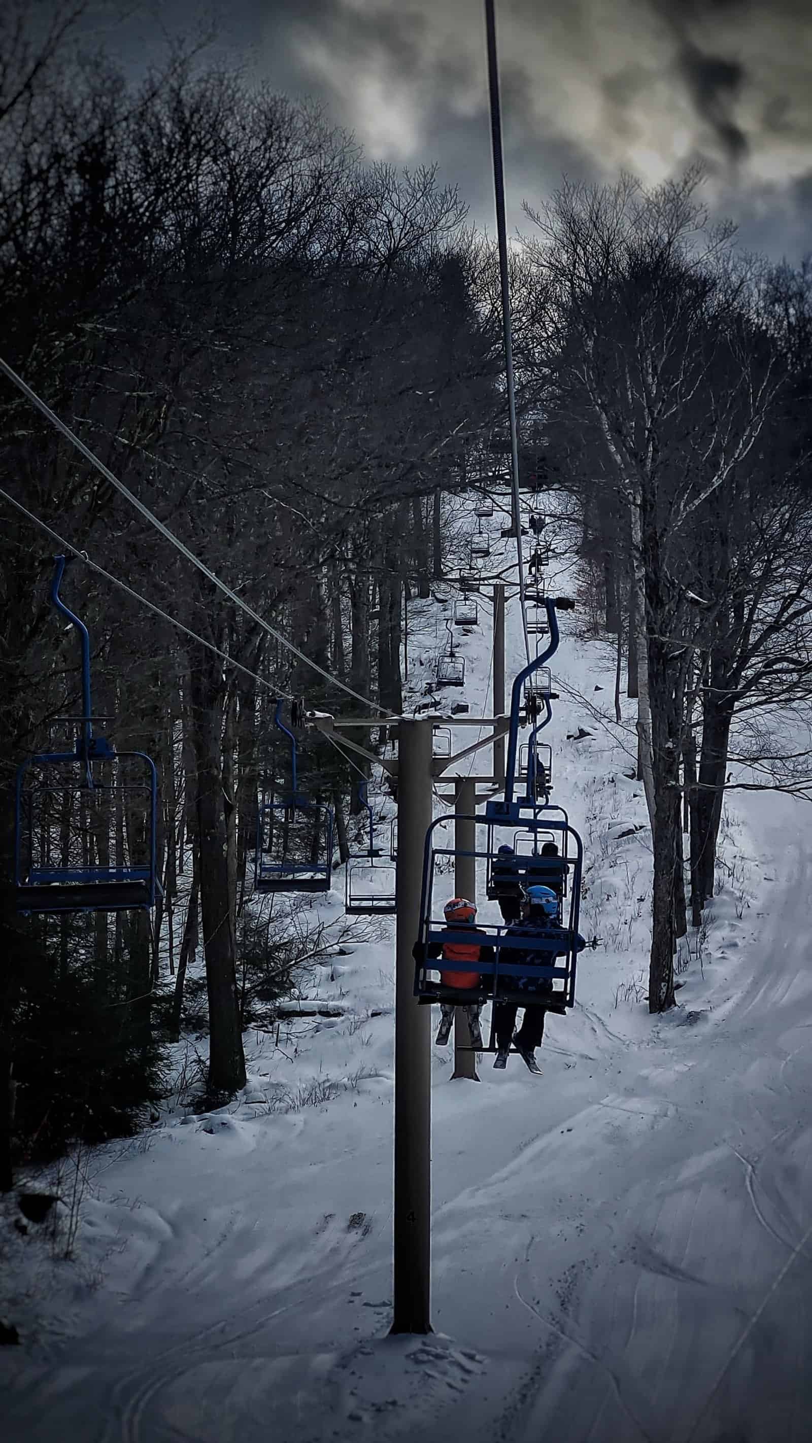 Otis ridge ski area: a small, cheap, charming berkshires hill 17 » 2026 » roaming sparrow Kids riding the chairlift up the hill at Otis Ridge Ski Area
