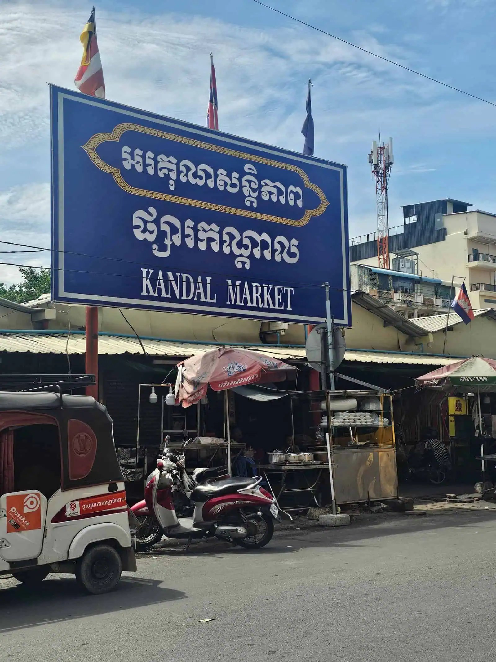 Phnom penh on foot: bassac lane, the riverside, and a day of wandering 21 » 2026 » roaming sparrow A busy Phnom Penh street with food carts and motorbikes