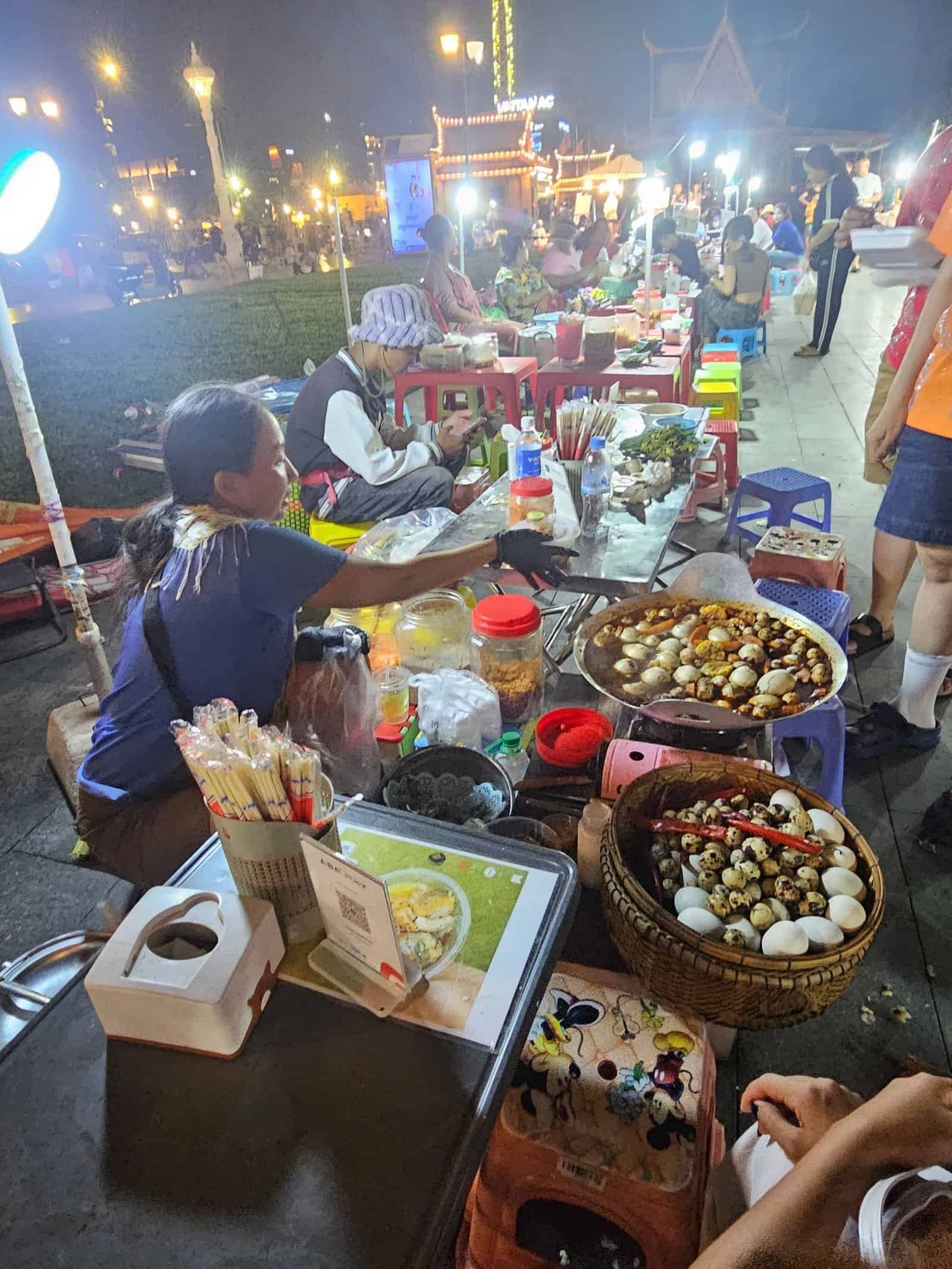 Phnom penh on foot: bassac lane, the riverside, and a day of wandering 25 » 2026 » roaming sparrow Lit-up wooden river cruise boats on the Phnom Penh riverside at night