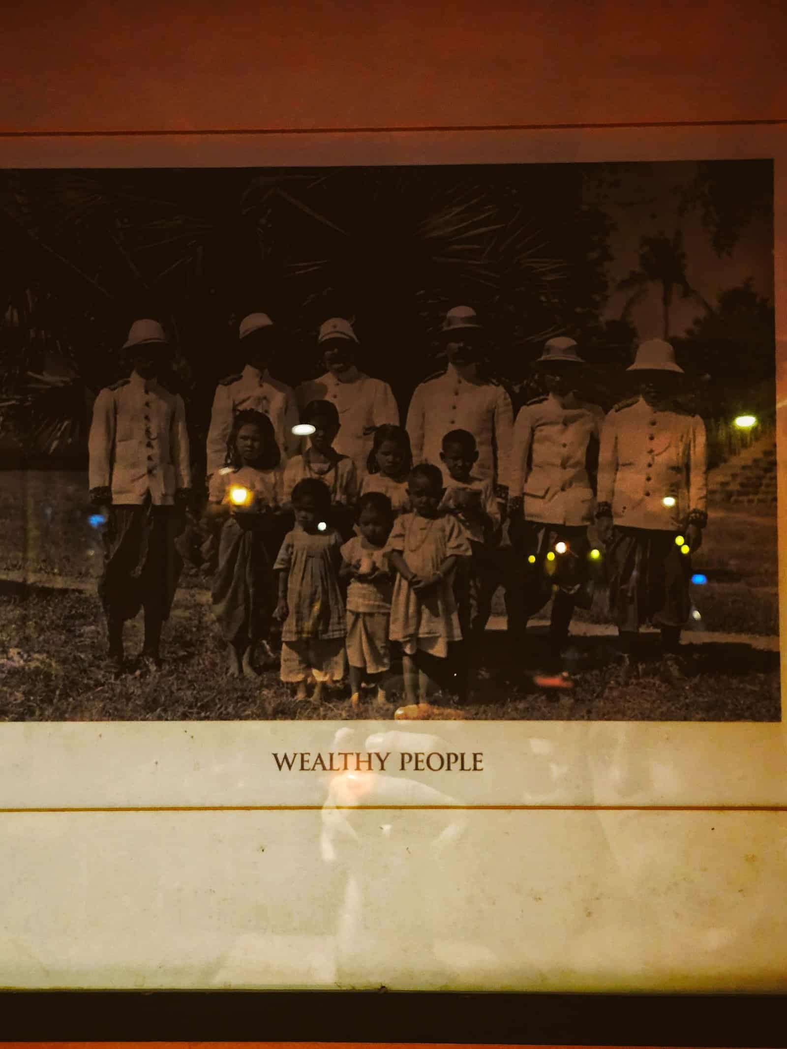 A framed colonial-era photo captioned Wealthy People on a Siem Reap bar wall