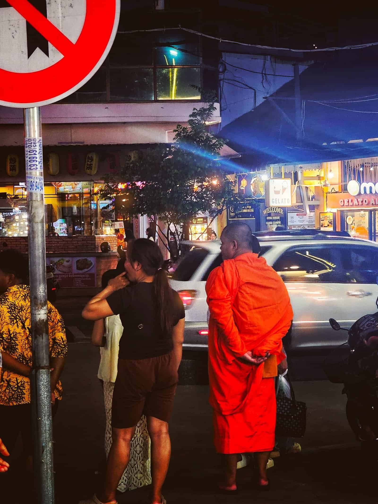 A statue of a woman with ferns for hair on a Siem Reap street at night